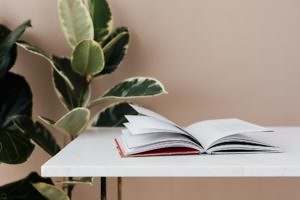 book placed on white table in cozy room